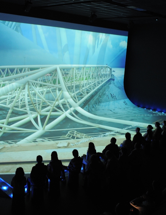 Immersive Design at World Expo Zaragoza: Dutch Pavilion Exhibition. Experience the essence of Water and Sustainable Development through our captivating Dutch Pavilion exhibition. As visitors stand on the 'shore,' they are treated to a cinematic journey about water and the Netherlands through an impressive floor and wall projection. Design by Studio Königshausen.